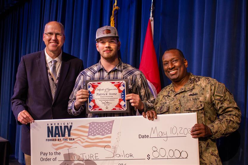 A student is honored for serving in the US Armed Forces after high school